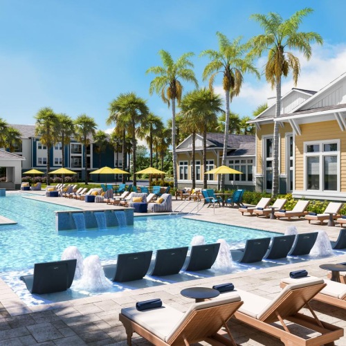 a swimming pool with lounge chairs around it